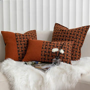 Three rectangular throw pillows with textured caramel color velvet cushion cover in burnt orange and dark brown tones on sofa