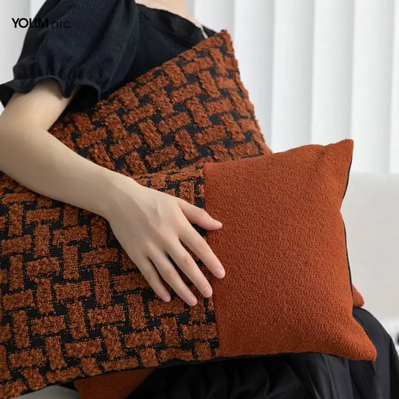 A cozy caramel color velvet cushion cover with a textured terracotta and black woven pattern for living room decorbites