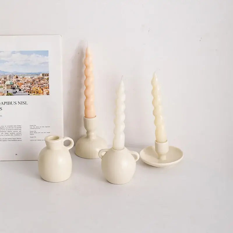 Cream-colored ceramic candle holder set with twisted peach and off-white tapered candles from decorbites geometric ceramic candle collection