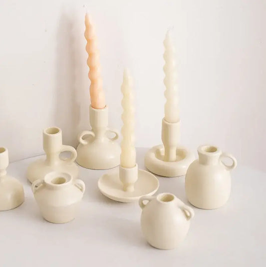Cream-colored geometric ceramic candle holders with twisted wax candles for living room decorbites geometric ceramic decor