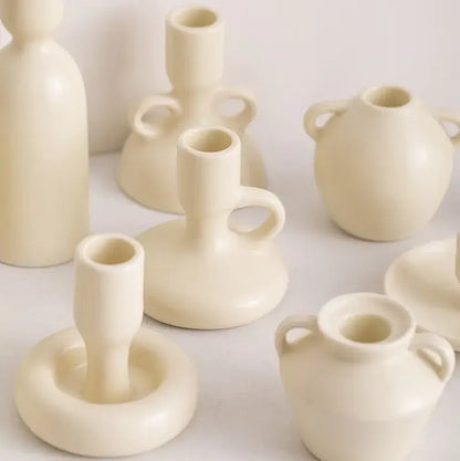 Cream-colored decorbites geometric ceramic candle holder set with smooth minimalist design and handle accents for living room decor