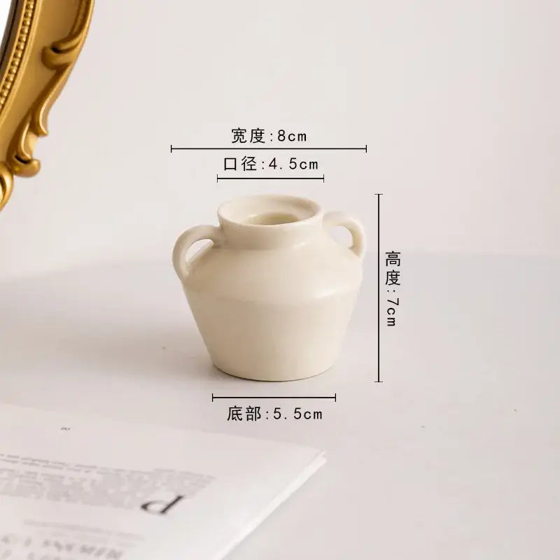 Cream-colored ceramic vase with two handles and rounded body from decorbites geometric ceramic candle holder set for living room decor