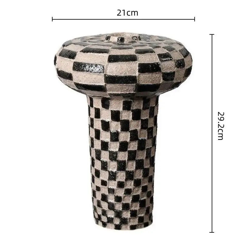A black and beige geometric check ceramic vase with rounded top and cylindrical base for decorbites geometric check decor