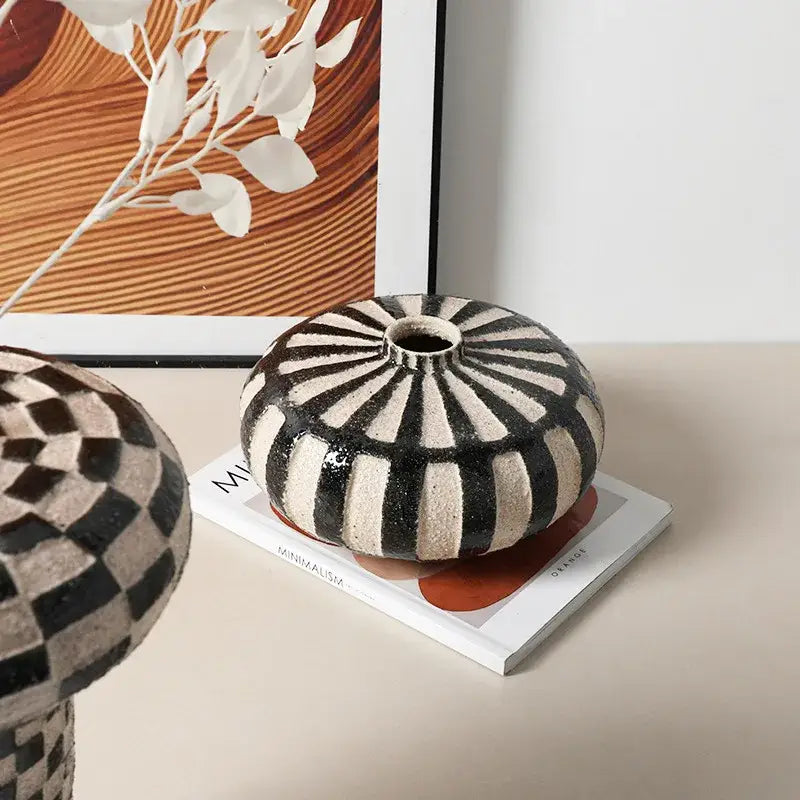 A round geometric check ceramic vase with bold black and beige radial stripes for living room decorbites decor