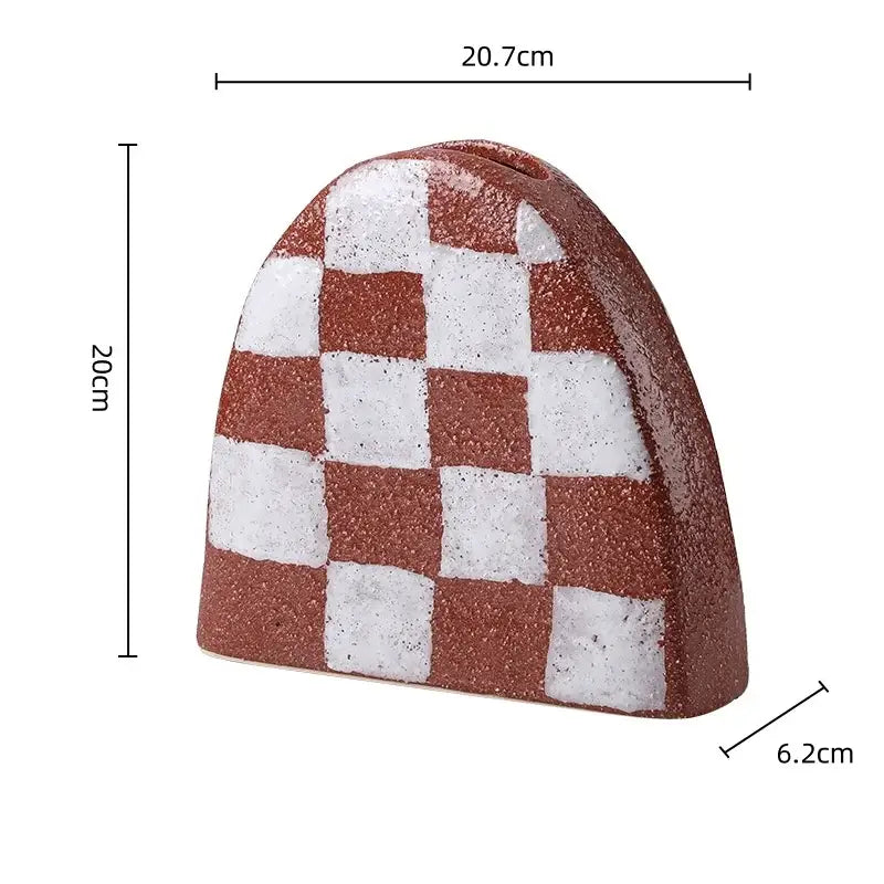 A geometric check ceramic money box with red and white checkered textured surface for living room decorbites decor
