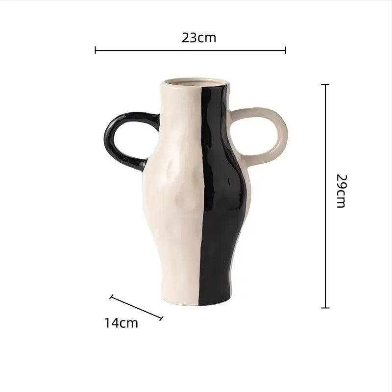 A two-toned ceramic vase with glossy black and matte off-white geometric check pattern and sculptural handles for living room decor