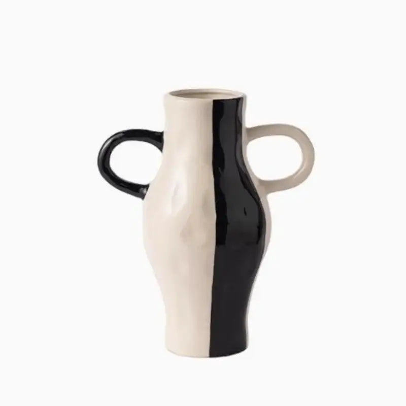 A sleek two-toned ceramic vase with geometric check pattern in black and white featuring sculptural handles for living room decor