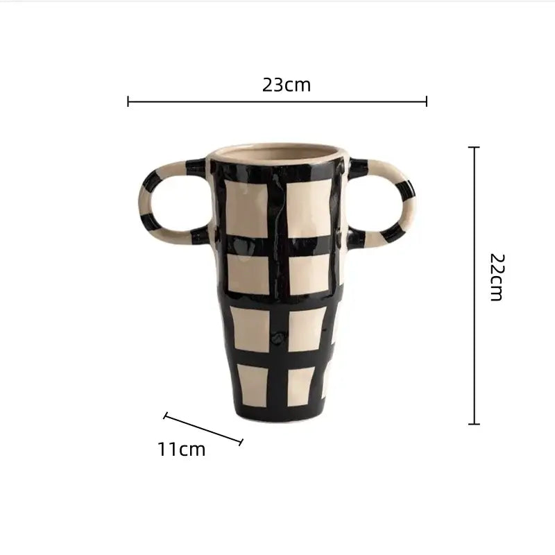 Black and cream ceramic vase with geometric check pattern and two looped handles for living room decor