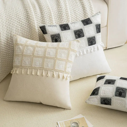 Cream-colored cushion cover with black and white crochet geometric checker pattern and tassel trim for living room decorbites geometric checker cushion