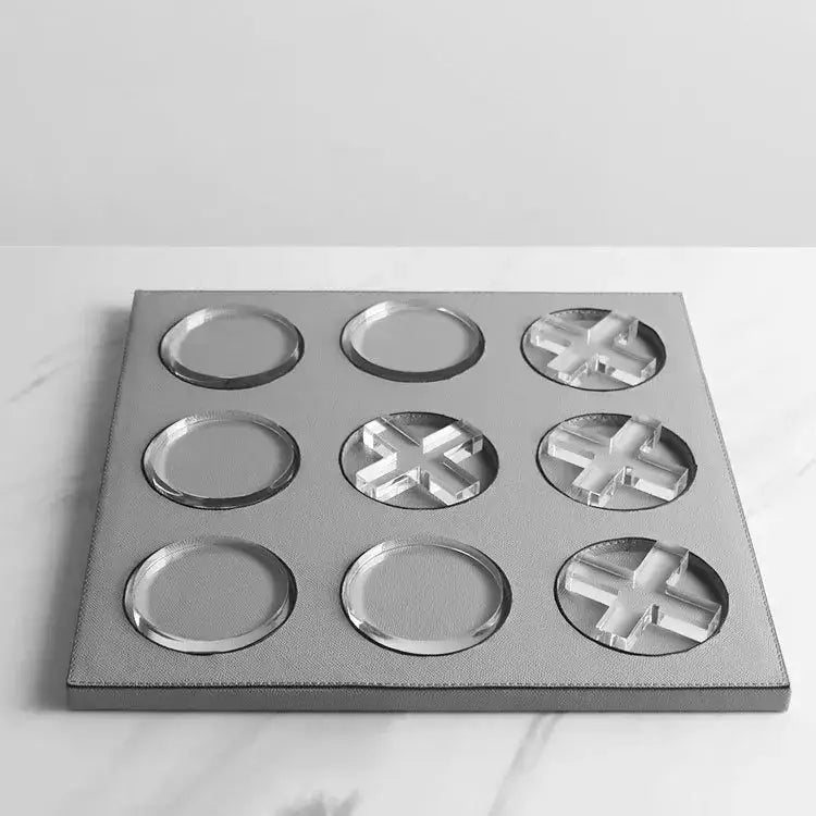 Silver leather tic-tac-toe game board with clear acrylic xs and os featuring geometric checkerboard grid for home decor
