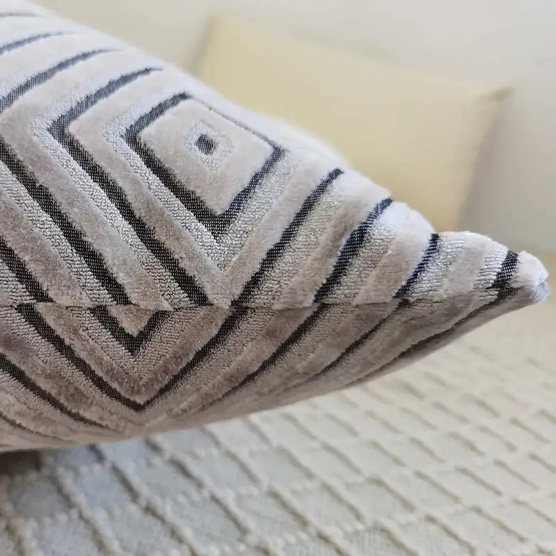 A soft gray chenille flocking cushion cover with bold black geometric patterns for living room decor by decorbites geometric chenille