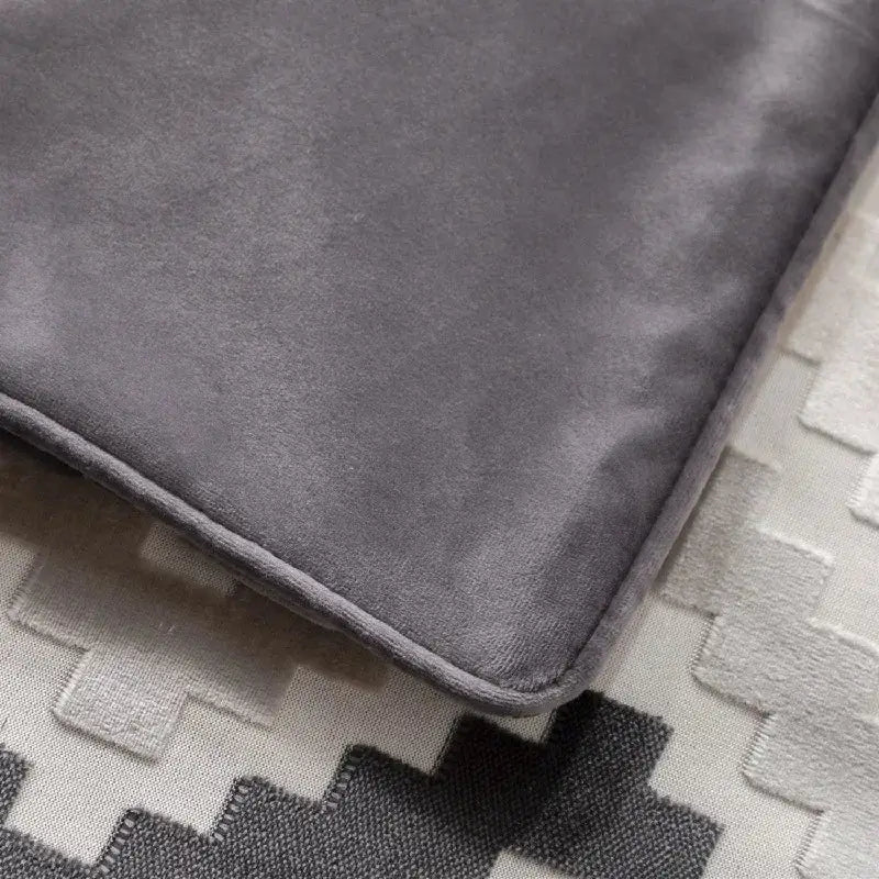 A soft dark gray velvet laptop sleeve with neatly stitched edges complementing decorbites geometric chenille flocking cushion cover