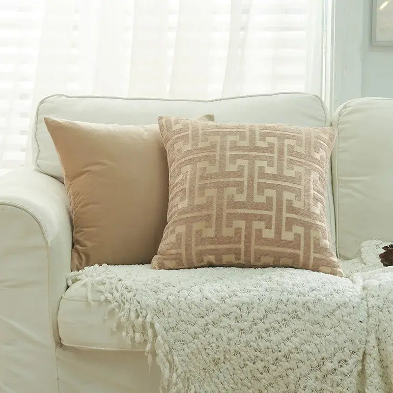 Beige geometric chenille throw pillowcase with textured fabric resting on white sofa for decorbites living room decor