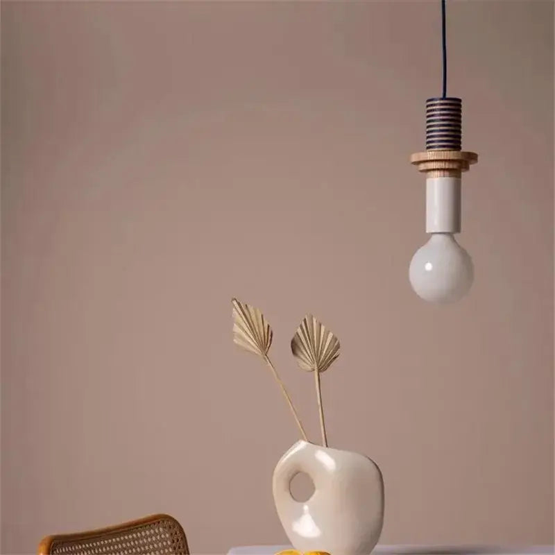 Minimalist pendant light with white bulb wooden accents and black coiled cord for decorbites led wooden bedroom decor