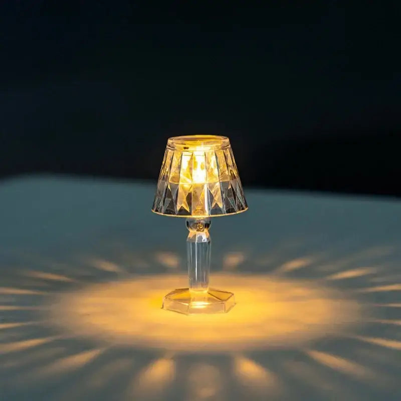 A clear crystal diamond night light with faceted geometric shade and base for bedroom reading by decorbites
