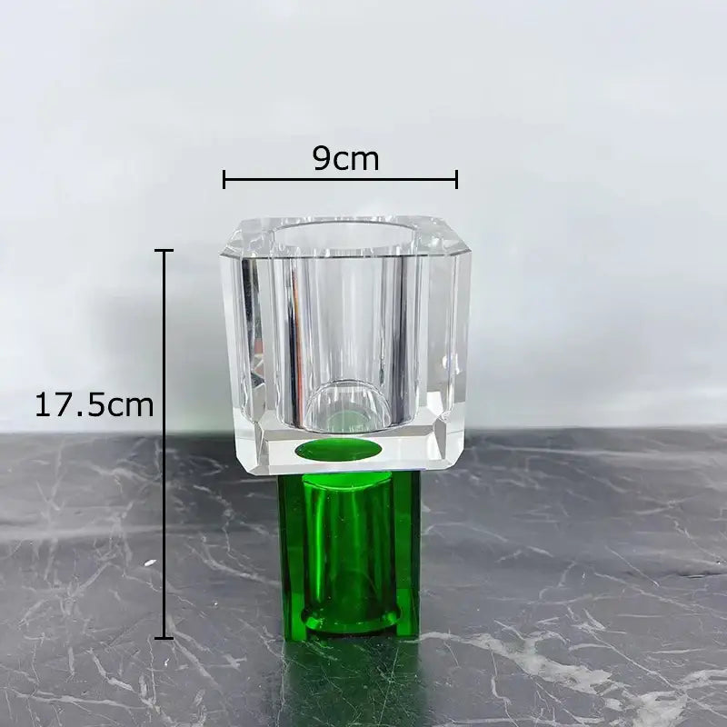 Clear faceted crystal glass vase with green base featuring artificial flowers for modern living room decorbites decor