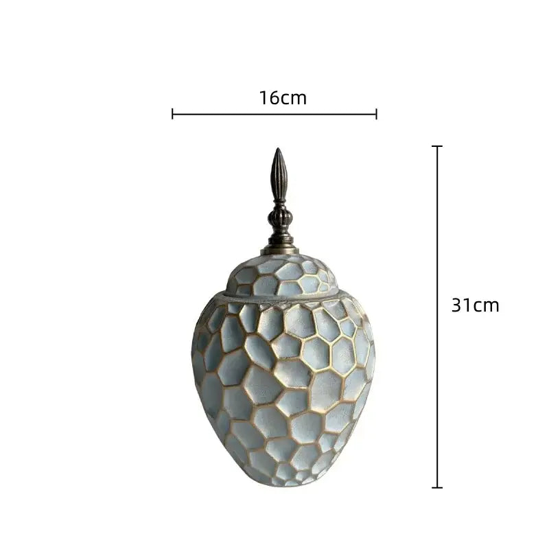 A 31cm tall light gray ceramic vase with geometric diamond check honeycomb pattern and ornate dark metal lid