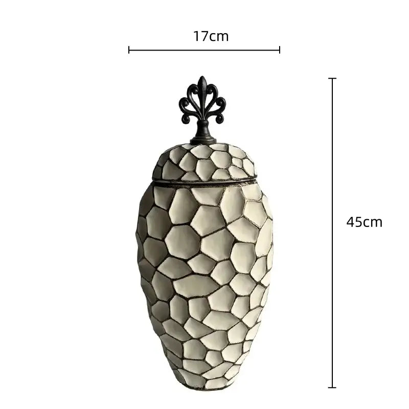 An elegant off-white ceramic vase with geometric diamond check pattern and black wrought iron lid for living room decor