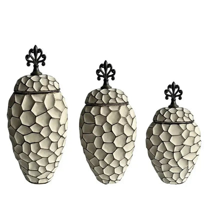 Set of three cream-colored ceramic vases with geometric diamond check pattern and black wrought iron lids for living room decor