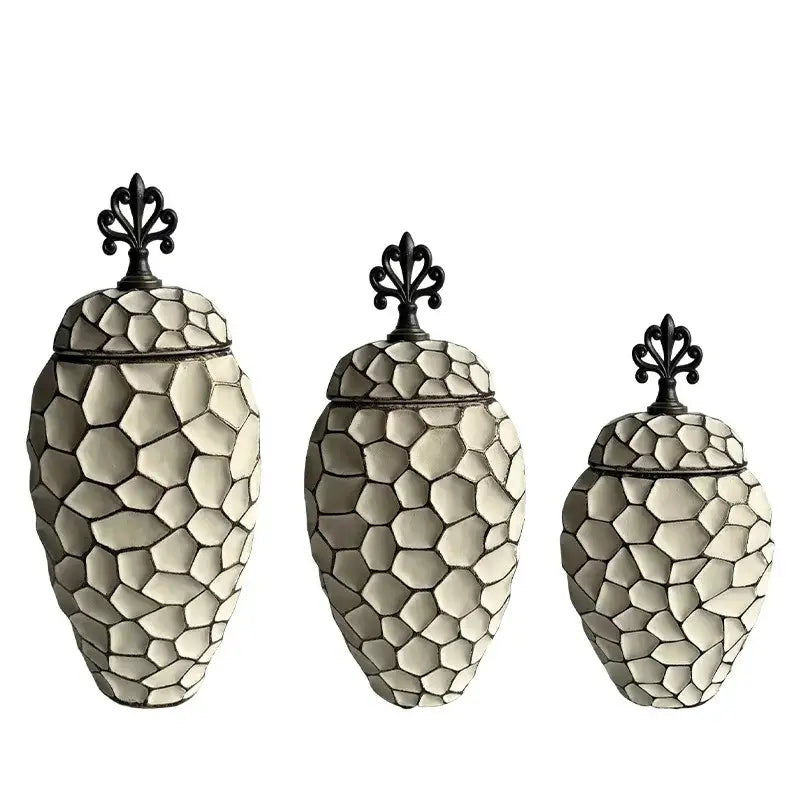 Set of three cream-colored ceramic vases with geometric diamond check pattern and black wrought iron lids for living room decor