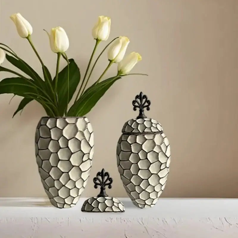 A sleek gray ceramic vase with geometric diamond check pattern and matching lid for living room decor