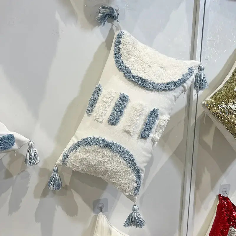 White rectangular pillow with blue and white textured fringe and tassels featuring decorbites geometric diamond tufted embroidery