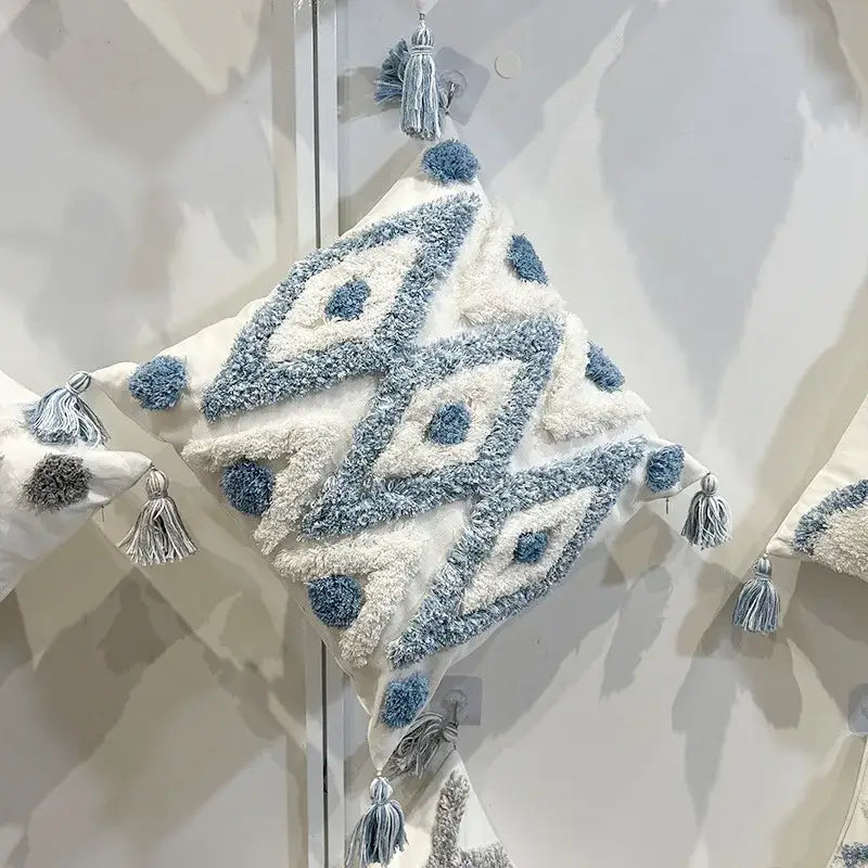 A cozy cream pillow with decorbites geometric diamond tufted embroidery in blue and white for living room decor