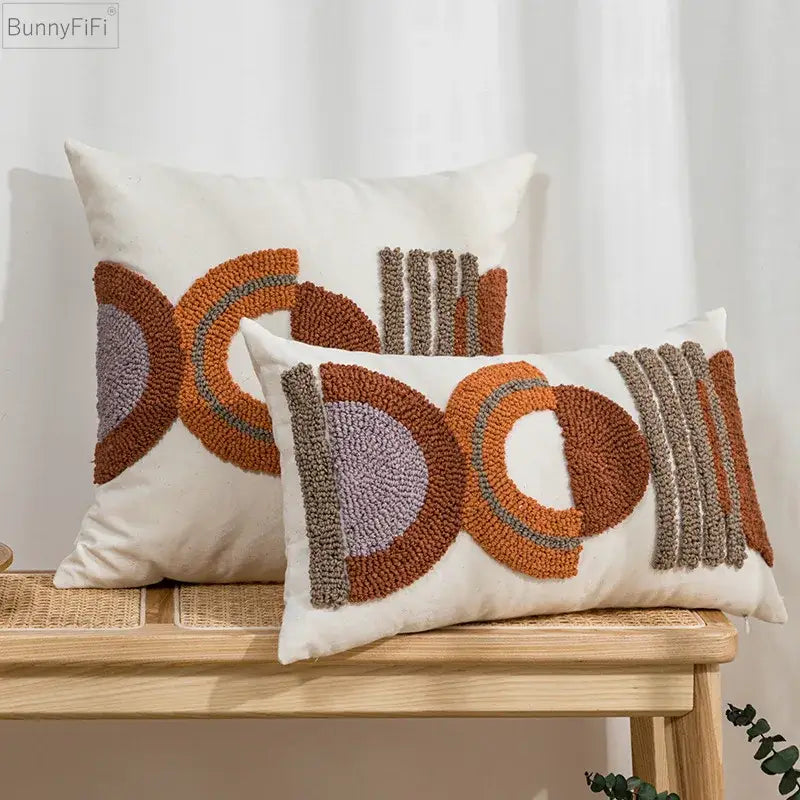 Cream-colored rectangular cushion cover with rust orange gray and beige geometric embroidered pattern for home decor
