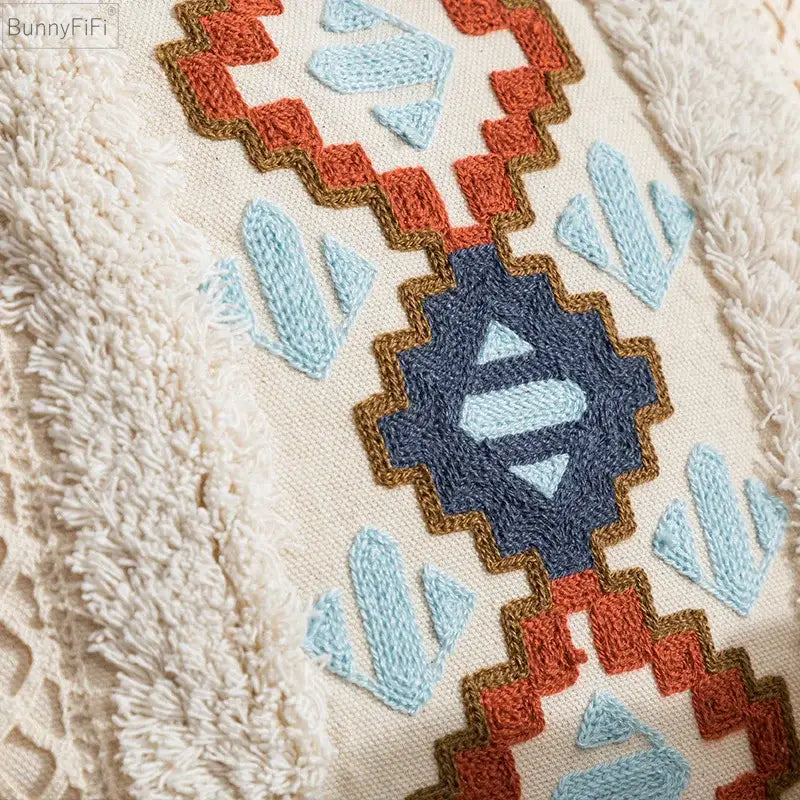 Cream-colored cushion cover with intricate navy blue light blue and terracotta geometric embroidery for home decor by decorbites