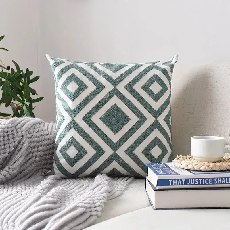 Square cushion cover with teal and white geometric embroidered pattern featuring textured decorbites embroidery for living room decor
