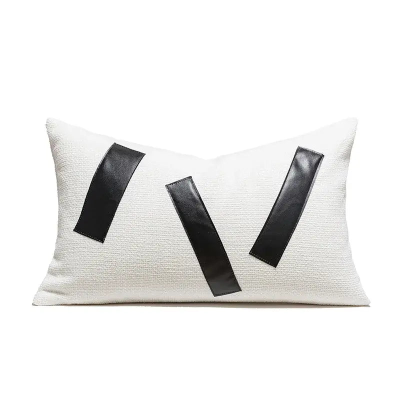 White textured cushion cover with black leather w pattern and tufted tassels decorbites geometric embroidered design