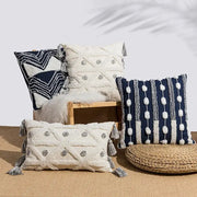 Cream-colored cushion cover with geometric embroidery and gray tufted tassels for decorbites bedroom decor