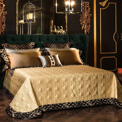 Luxurious emerald green tufted velvet headboard with ornate gold trim in a geometric embroidered egyptian cotton bedding set