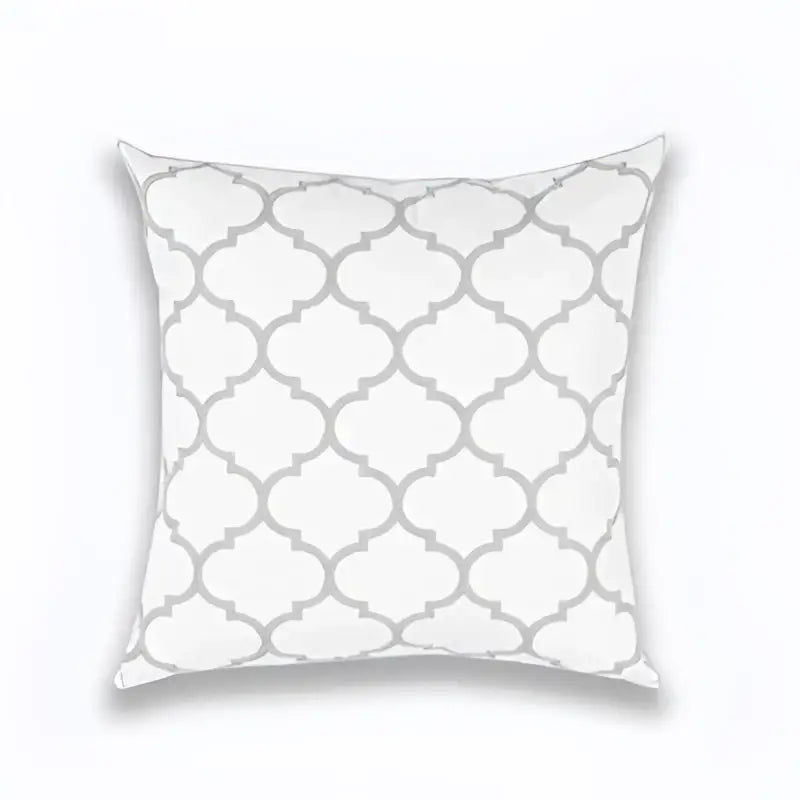 White throw pillow with repeating gray quatrefoil pattern in geometric embroidered light grey cotton cushion cover decorbites