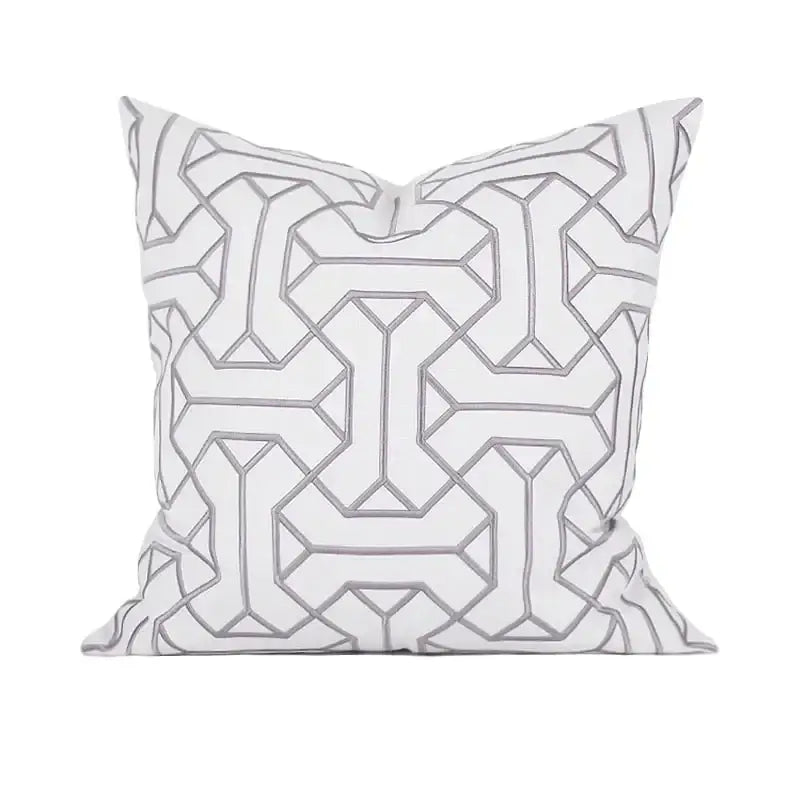 White throw pillow with intricate gray geometric embroidery in a repeating pattern from decorbites geometric embroidered cushion covers