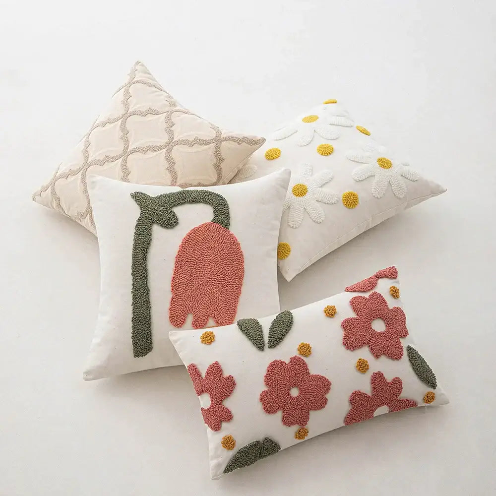 White cushion with pink and green embroidered flowers featuring decorbites geometric embroidery beige cushion cover