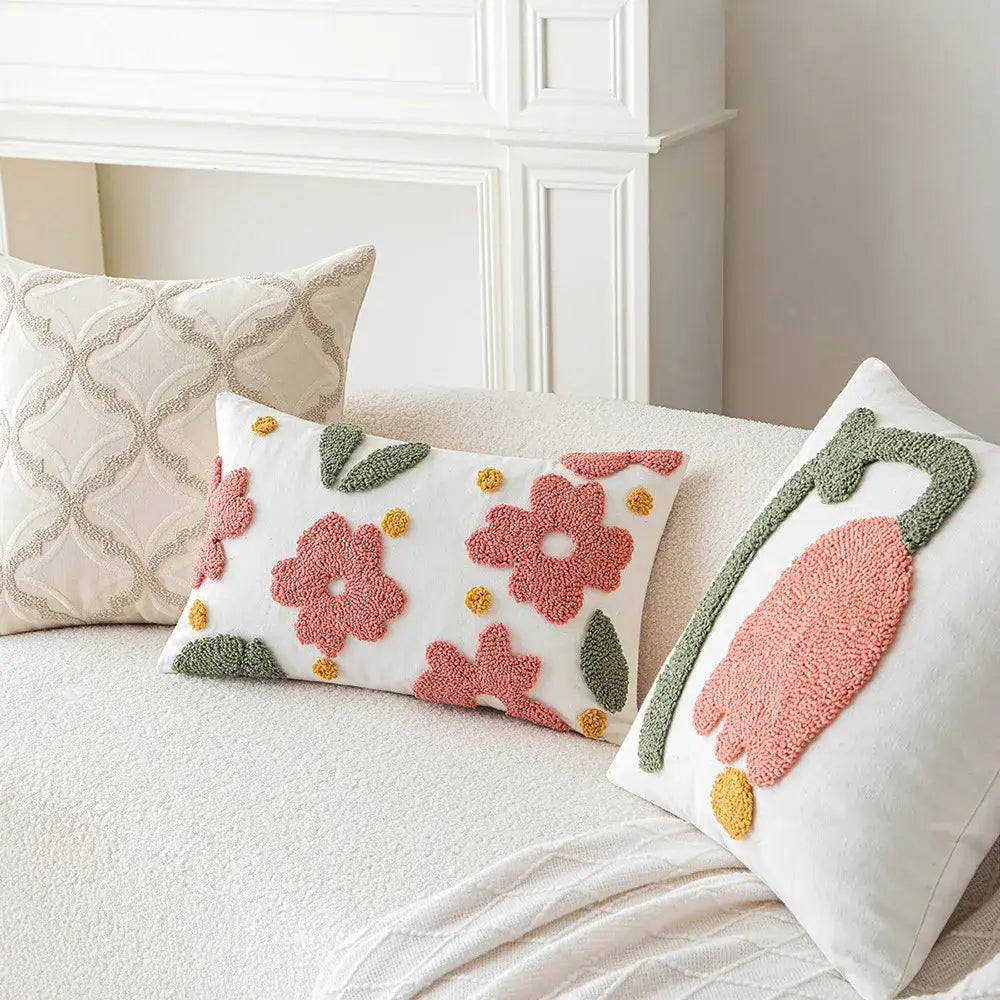 White rectangular cushion cover with pink and green floral embroidery yellow pom-poms decorbites geometric embroidery