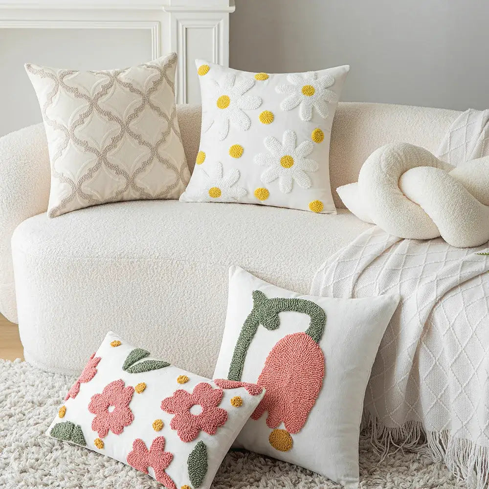 White throw pillows with colorful embroidered floral and daisy designs featuring decorbites geometric embroidery cushion cover