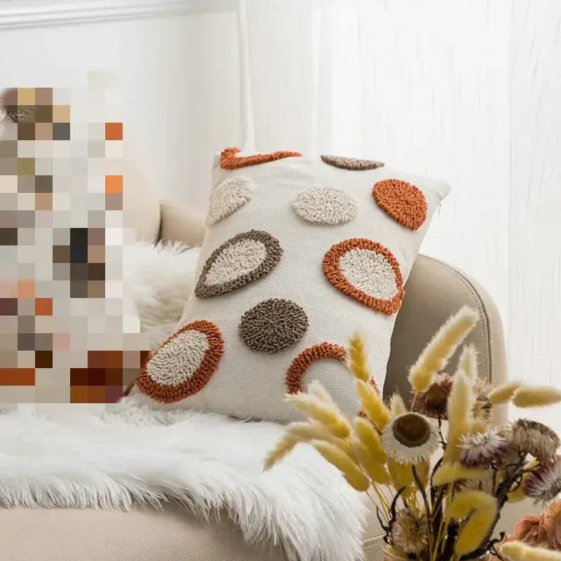 Cream-colored cushion cover with decorbites geometric embroidery circle patterns in terracotta and muted brown tones for living room decor