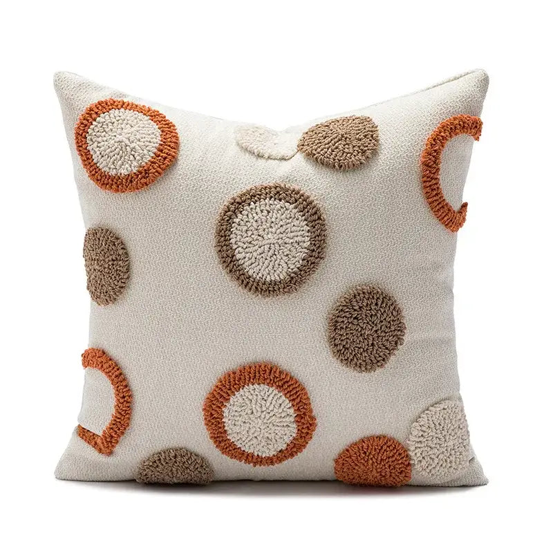 Cream-colored cushion cover with decorbites geometric embroidery circle patterns in earthy orange and brown tones for living room decor