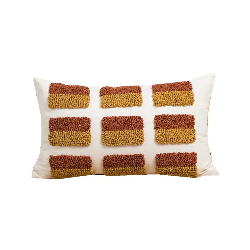 Cream-colored rectangular cushion cover with textured tufted geometric embroidery in earthy brown and mustard tones for decorbites decor
