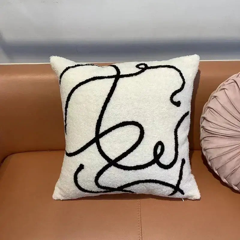 Cream-colored plush throw pillow with bold black line design featuring decorbites geometric embroidery cushion covers