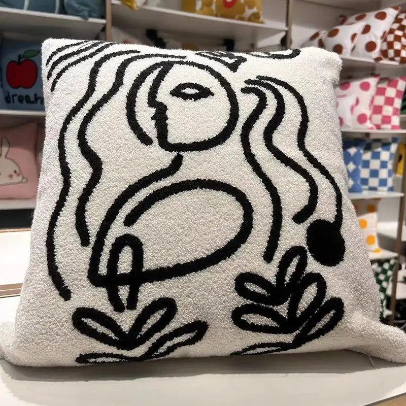 White textured throw pillow with bold black abstract line art of face and foliage featuring decorbites geometric embroidery cushion cover