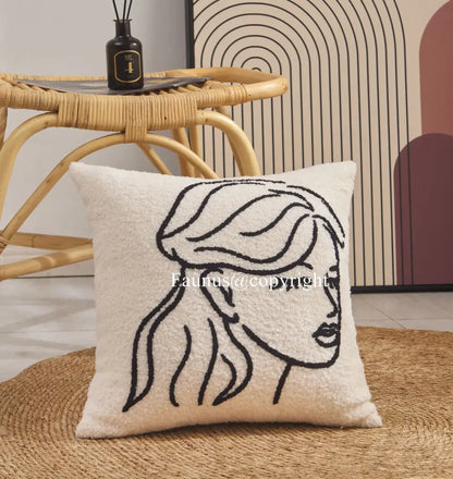 Cream cushion cover with geometric embroidery featuring a black line-art portrait for living room decorbites decor