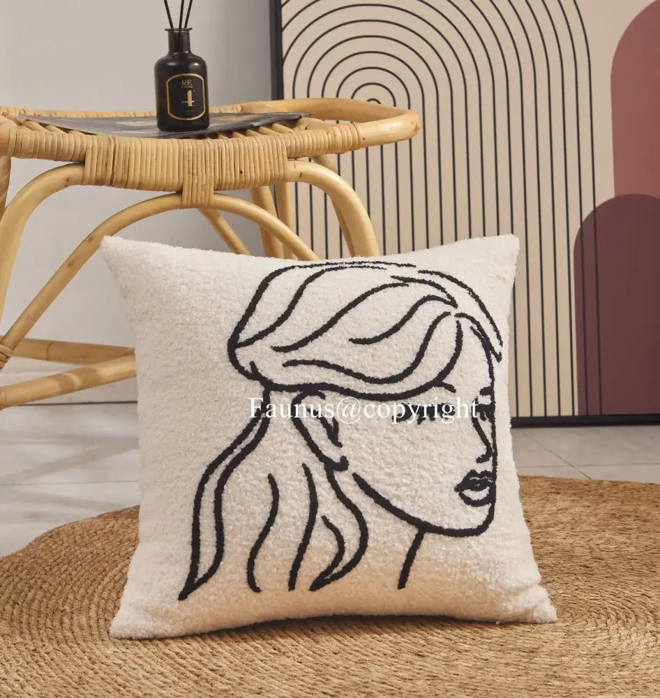 Cream cushion cover with geometric embroidery featuring a black line-art portrait for living room decorbites decor