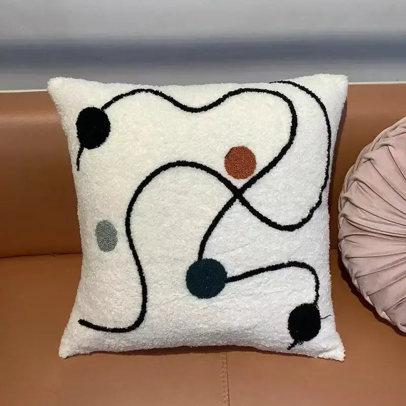 White fluffy throw pillow with abstract black line design and colorful accents featuring decorbites geometric embroidery cushion cover