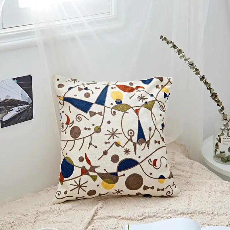 Cream cushion cover with colorful abstract geometric embroidery by decorbites for black and grey living room decor