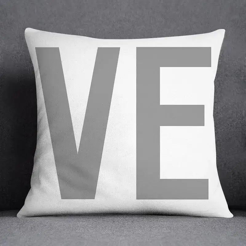 White throw pillow case with bold gray ve lettering featuring decorbites geometric floral print for living room decor