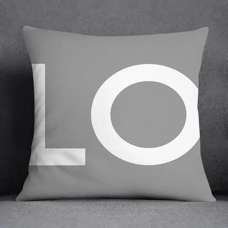 Gray pillow case with bold white lo lettering in modern font featuring decorbites geometric floral print design