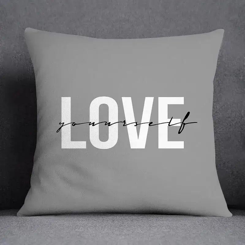 Gray pillow case with love yourself print in white block and black cursive script for decorbites geometric floral print decor